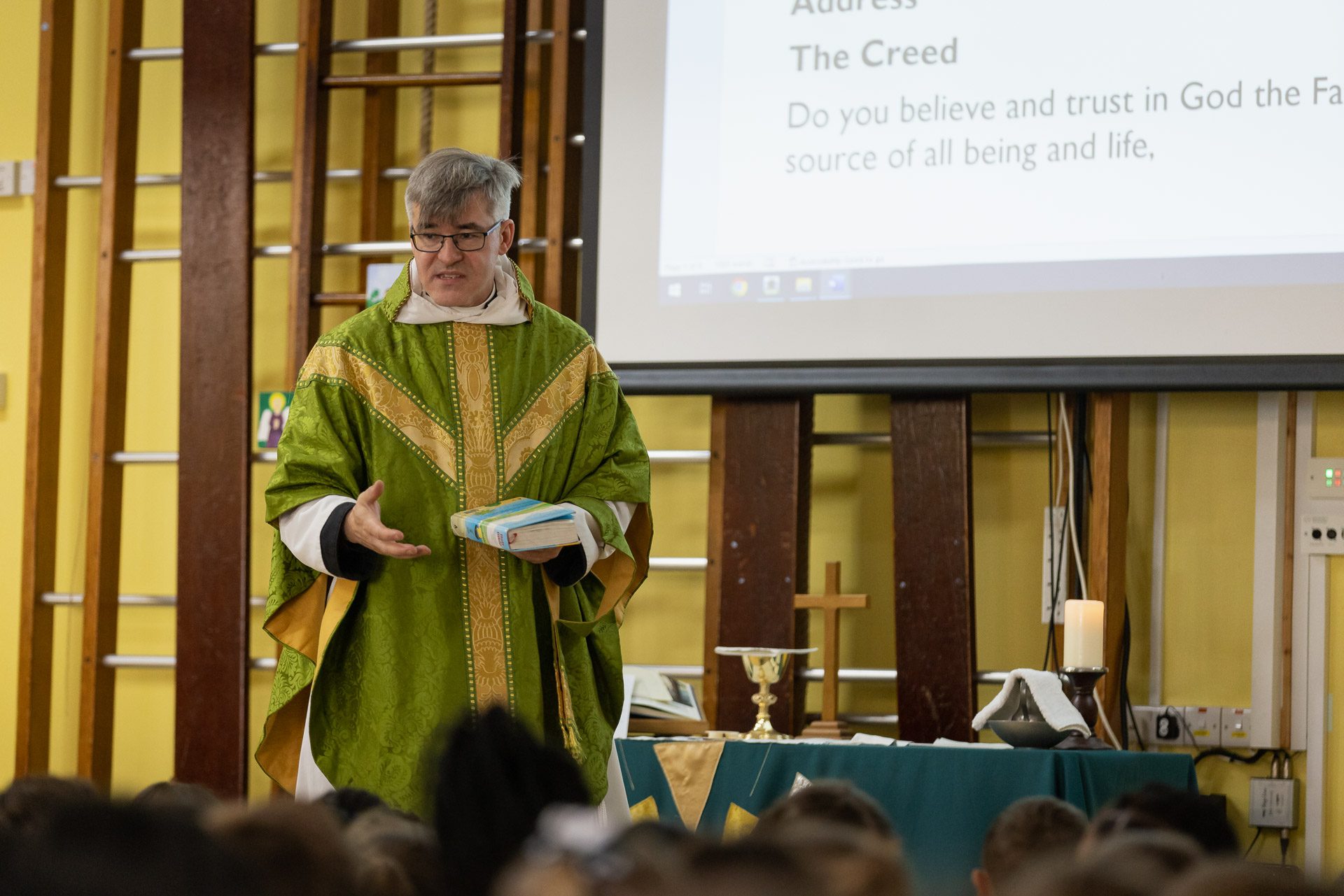 Clergyman delivering a sermon to the kids